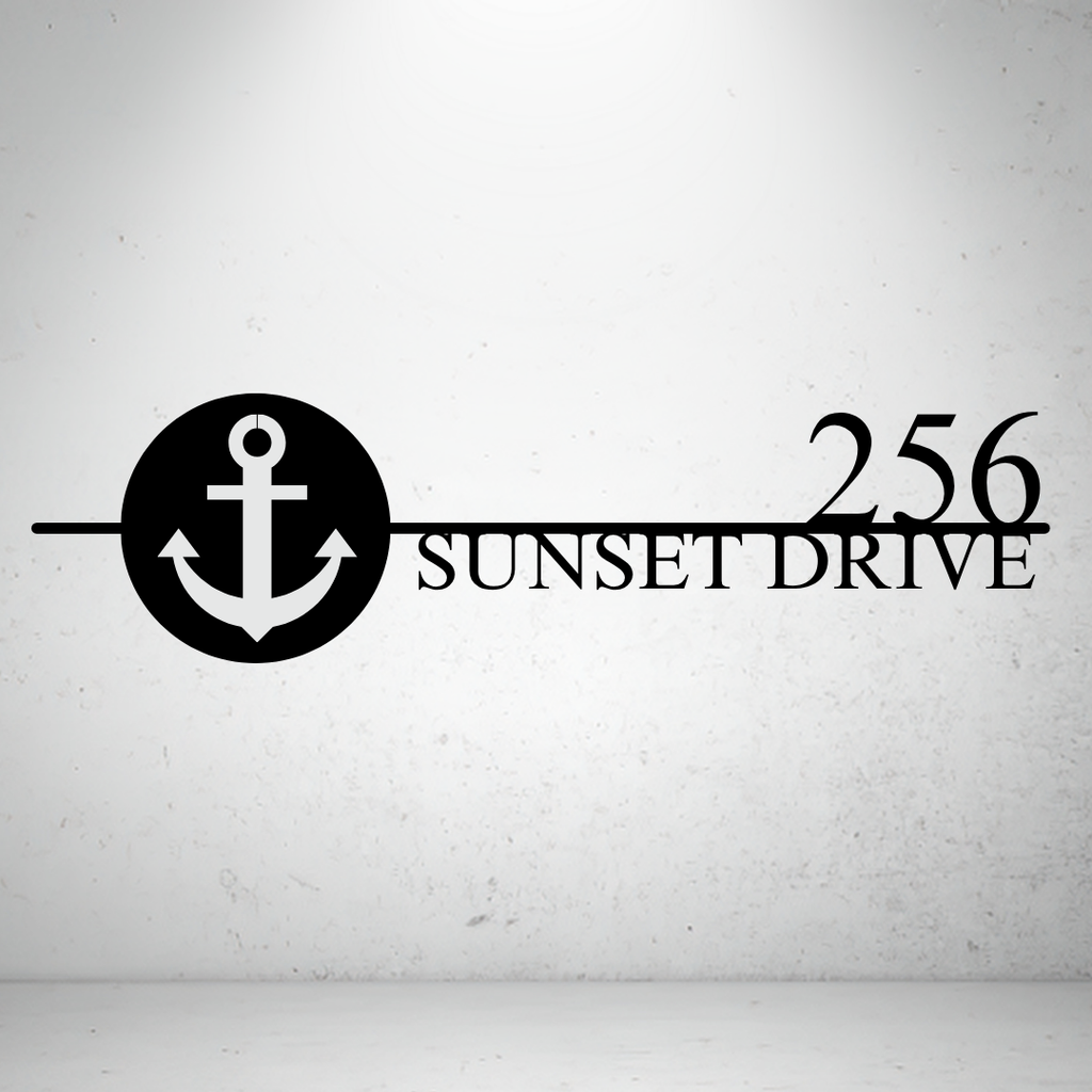 Metal house number sign with nautical anchor design on a grey background