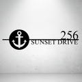 Metal house number sign with nautical anchor design on a grey background