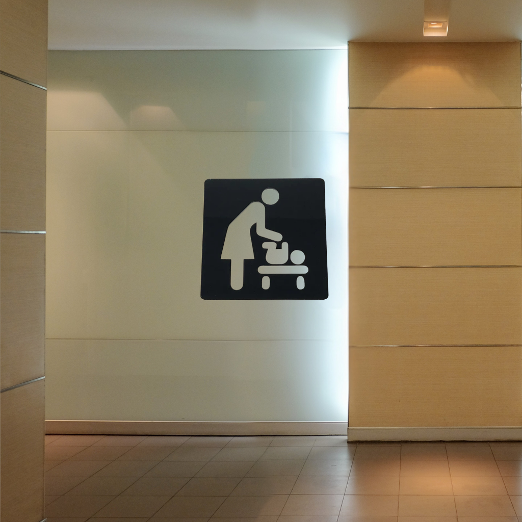 Baby Changing Station Metal Sign installed on a public restroom wall, providing clear directional signage for baby changing facilities.