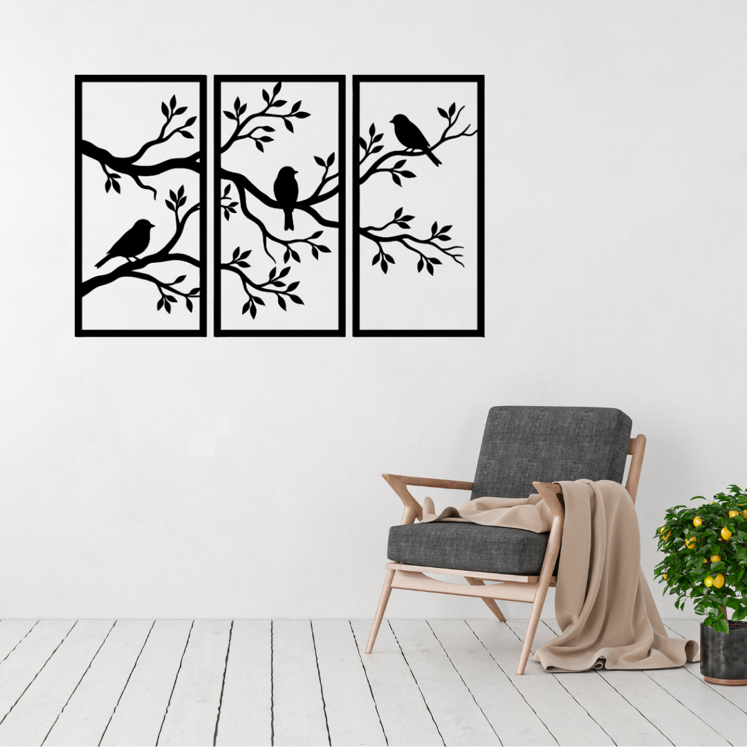 Birdsong Garden three panel birds and branches metal wall art displayed above a contemporary chair