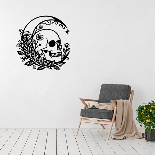 Bloom & Bone | Floral Skull Metal Wall Art displayed in a bright modern living room, featuring an intricately detailed human skull surrounded by blooming wildflowers, leafy botanical accents and a graceful crescent moon.