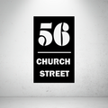 Modern metal address sign featuring a custom house number and street name separated by a minimalist horizontal divider.