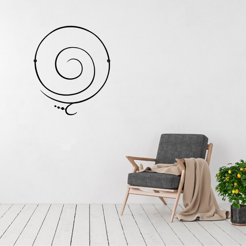 Minimalist spiral metal wall art displayed on a white wall in a modern living room with clean contemporary décor.