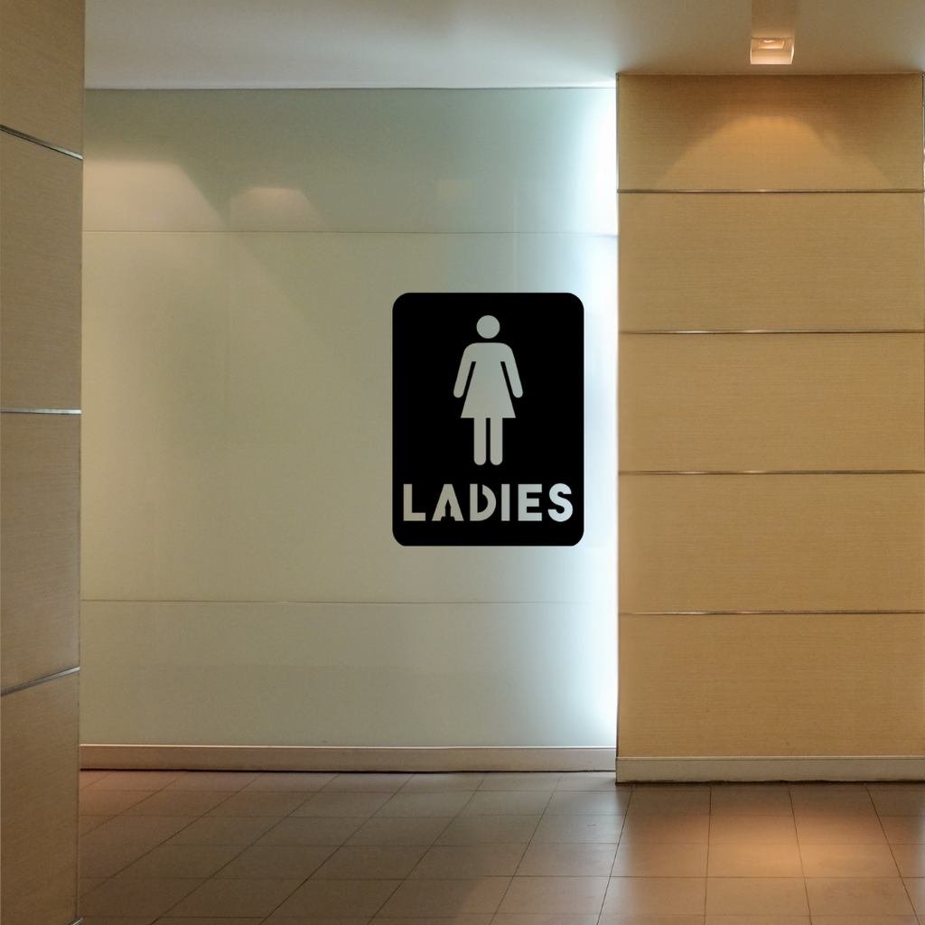 Ladies Bathroom Sign | Metal Toilet Sign mounted on a modern restroom wall in a commercial setting.