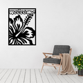 Coastal Retreat tropical hibiscus welcome metal wall panel displayed in a bright modern living room.