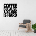 Coffee Because Adulting Is Hard | Funny Coffee Metal Wall Art displayed above a modern accent chair in a contemporary living space.