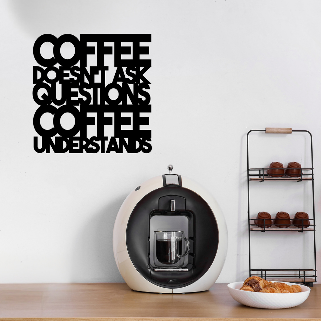 Coffee Doesn't Ask Questions, Coffee Understands | Funny Coffee Metal Wall Art showcased above a stylish home coffee station with an espresso machine and coffee accessories.