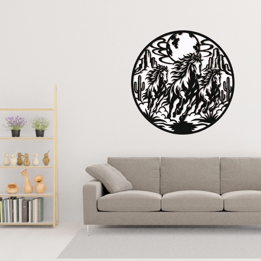 Desert Thunder | Wild Horses Metal Wall Art displayed above a modern grey sofa, featuring three wild horses galloping through a moonlit desert with mesas and cacti in a circular black metal wall art design.