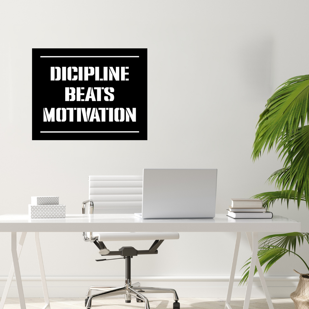 Discipline Beats Motivation inspirational metal wall art mounted above a modern office desk in a clean, minimalist workspace.