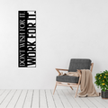 Don't Wish For It, Work For It motivational metal wall art displayed beside a modern accent chair, featuring bold vertical typography in laser-cut steel.