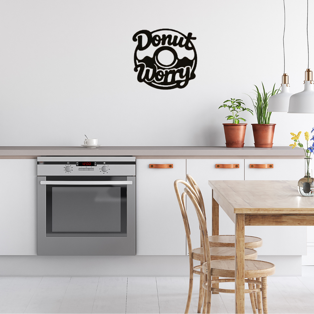 Donut Worry | Humorous Kitchen Metal Wall Art displayed in a stylish contemporary kitchen above the countertop.