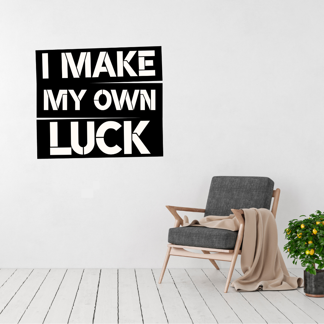 Driven by Determination | I Make My Own Luck Metal Wall Art displayed in a modern living room.