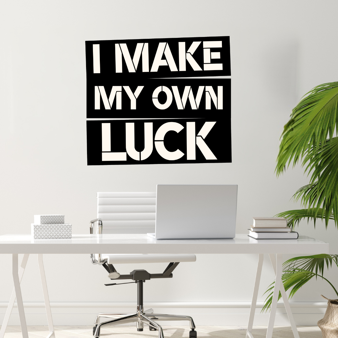Driven by Determination | I Make My Own Luck Metal Wall Art installed above a modern office desk.
