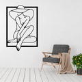 Elegant Mystery woman in hat metal wall art displayed above a contemporary chair in a stylish modern interior