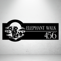 Elephant Walk personalised safari metal house number sign displayed on a concrete wall.