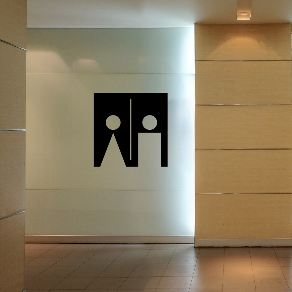 Essential Icons unisex toilet sign installed between restroom doors in a modern commercial interior.