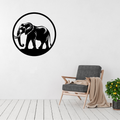 Gentle Giant | Elephant Metal Wall Art displayed in a modern minimalist living room, featuring a striking circular black metal silhouette of a majestic African elephant with sweeping tusks. Precision laser cut steel wall décor that brings the beauty and strength of wildlife into contemporary, safari-inspired and luxury home interiors.
