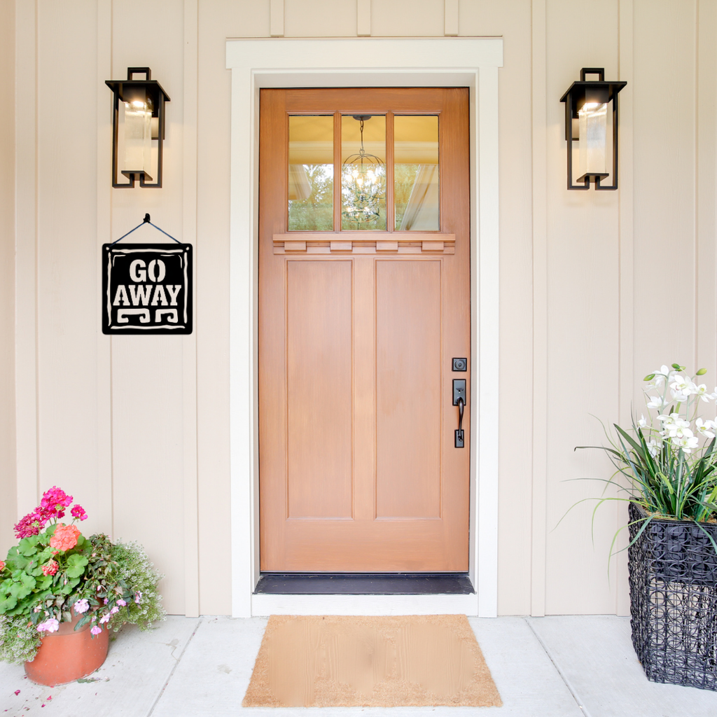 Go Away | Humorous Rustic Metal Wall Sign displayed beside a modern front entrance, showcasing its bold vintage typography and rustic framed design.