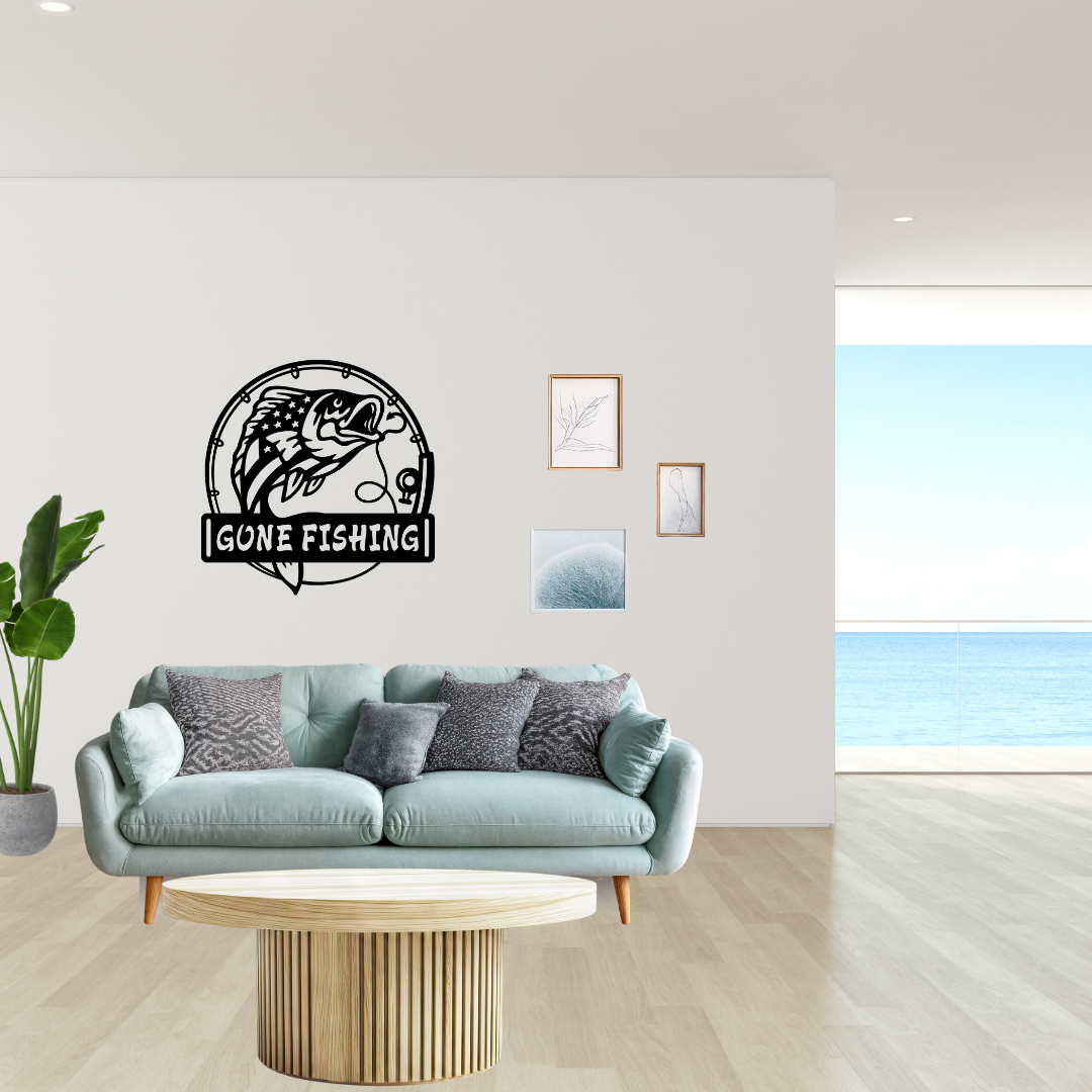 Gone Fishing metal wall décor mounted above a sofa in a bright contemporary living space overlooking the ocean.