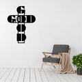 Goodness of God God Is Good cross metal wall art displayed above a contemporary chair in a modern interior