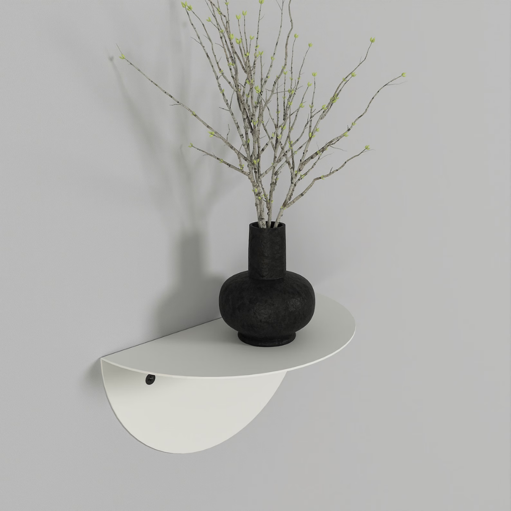 Modern white floating half-circle shelf mounted in a contemporary bedroom with decorative accessories