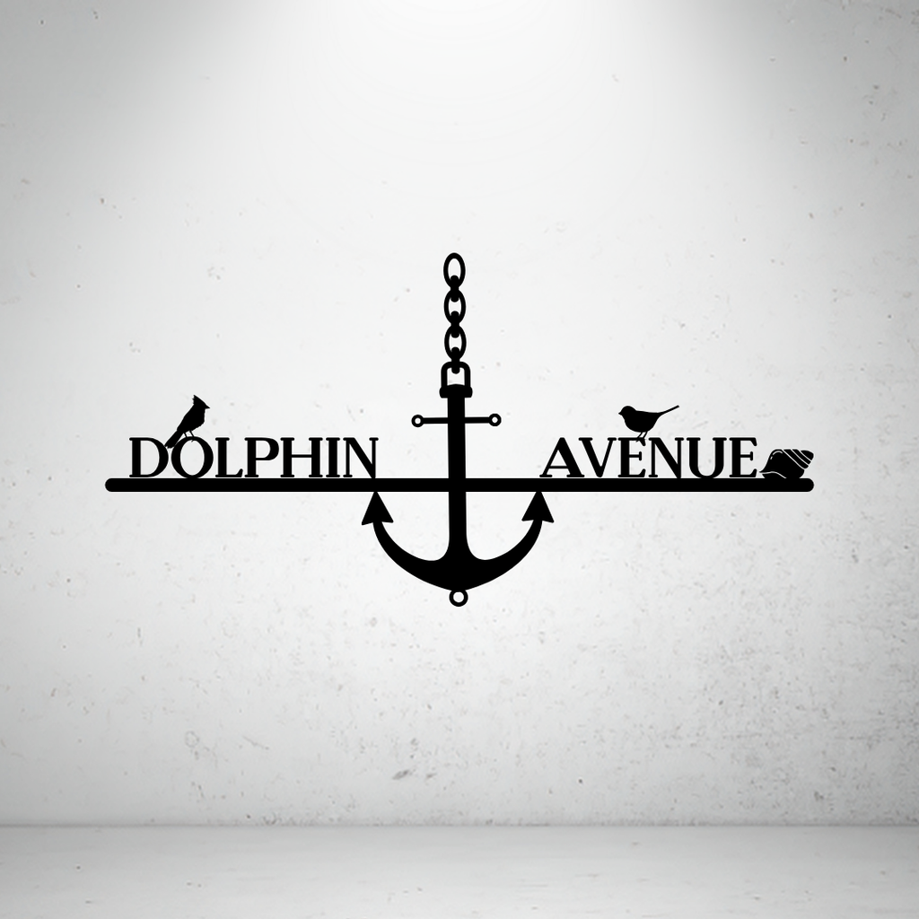 Metal house number and street name sign with anchor detail on a grey background
