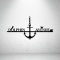 Metal house number and street name sign with anchor detail on a grey background