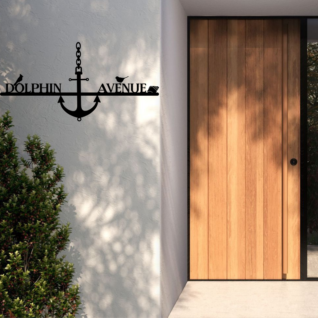 Metal house number nautical address sign displayed at a modern coastal house entrance