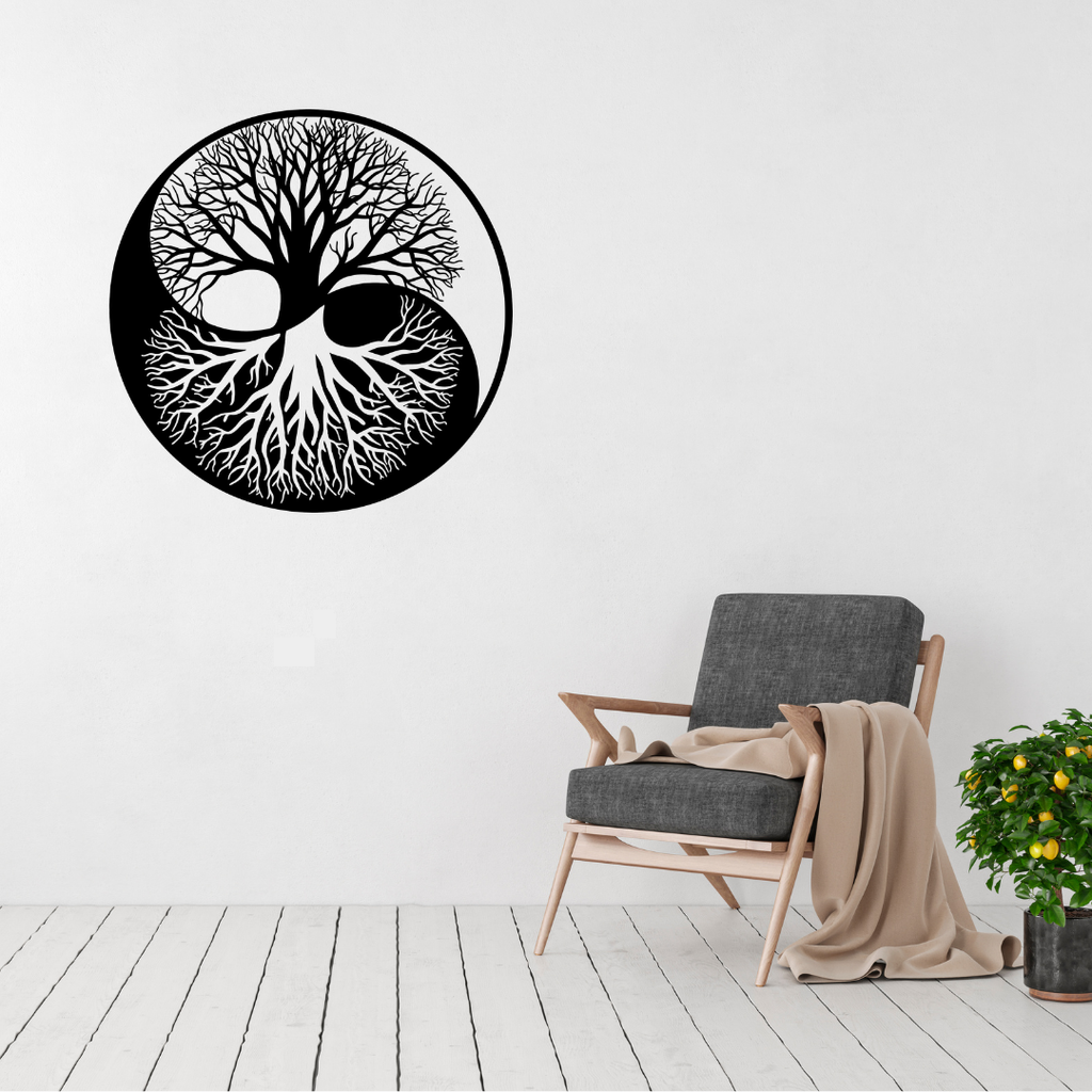 Yin Yang Tree of Life metal wall art displayed on a white wall above a modern lounge chair, creating a peaceful contemporary focal point.