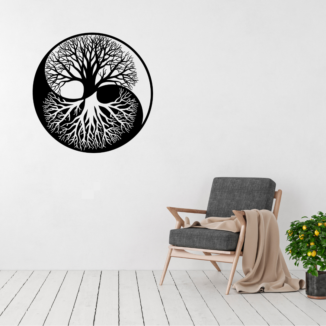 Yin Yang Tree of Life metal wall art displayed on a white wall above a modern lounge chair, creating a peaceful contemporary focal point.