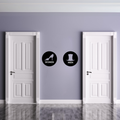 High Heel & Top Hat modern metal bathroom door signs displayed between two white restroom doors in a contemporary interior.