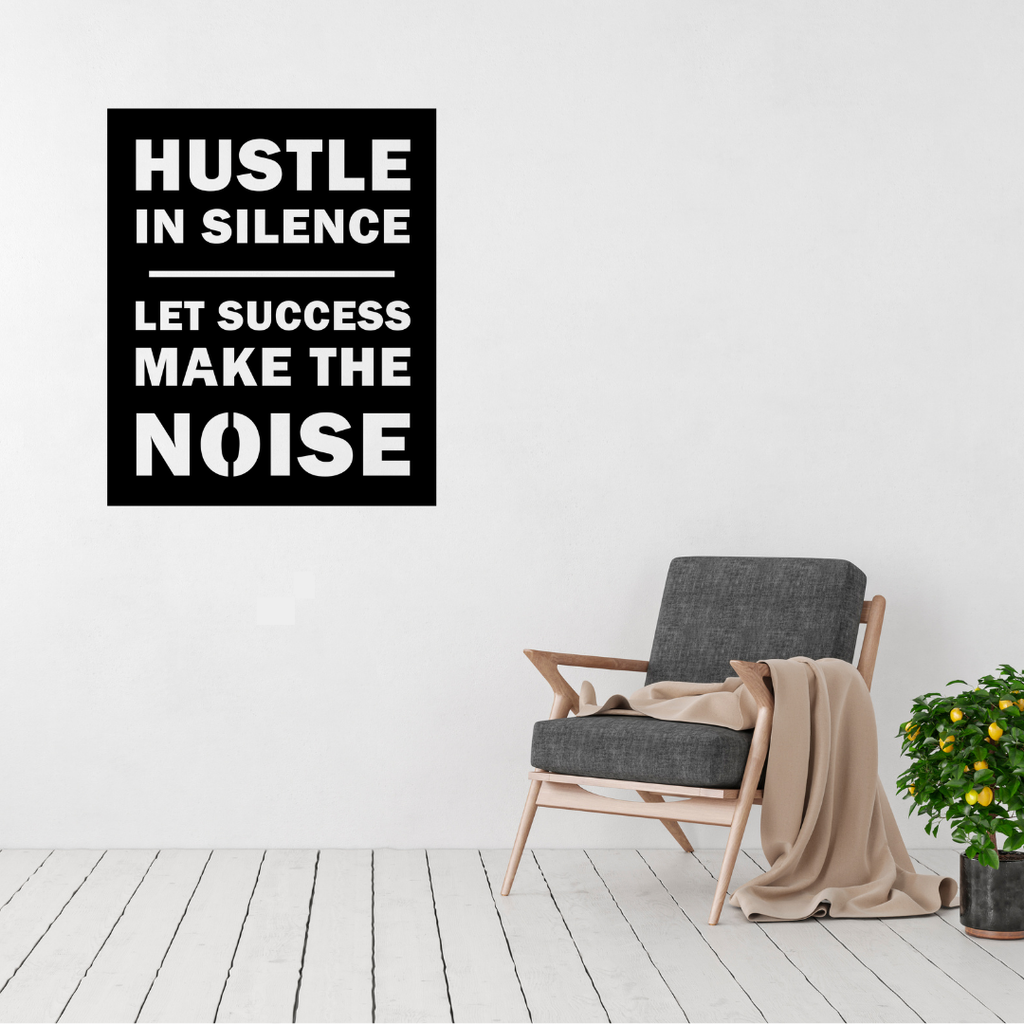 Hustle in Silence motivational metal wall art displayed on a bright modern living room wall.