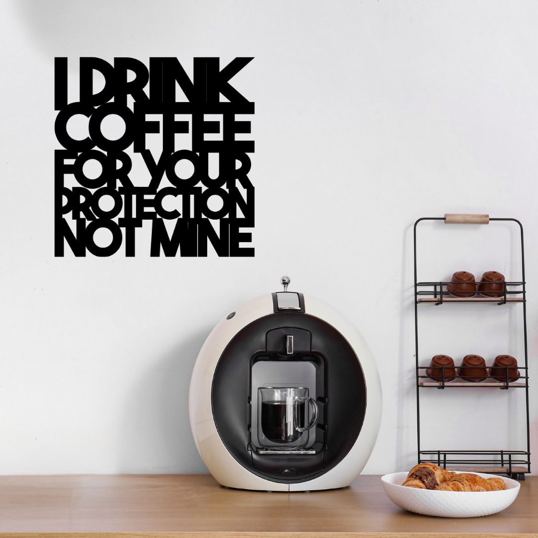 I Drink Coffee for Your Protection Not Mine | Funny Coffee Metal Wall Art showcased above a home coffee station with an espresso machine and coffee accessories.