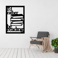 I'd Rather Be Reading | Book Stack Metal Wall Art displayed on a modern living room wall above a contemporary armchair.