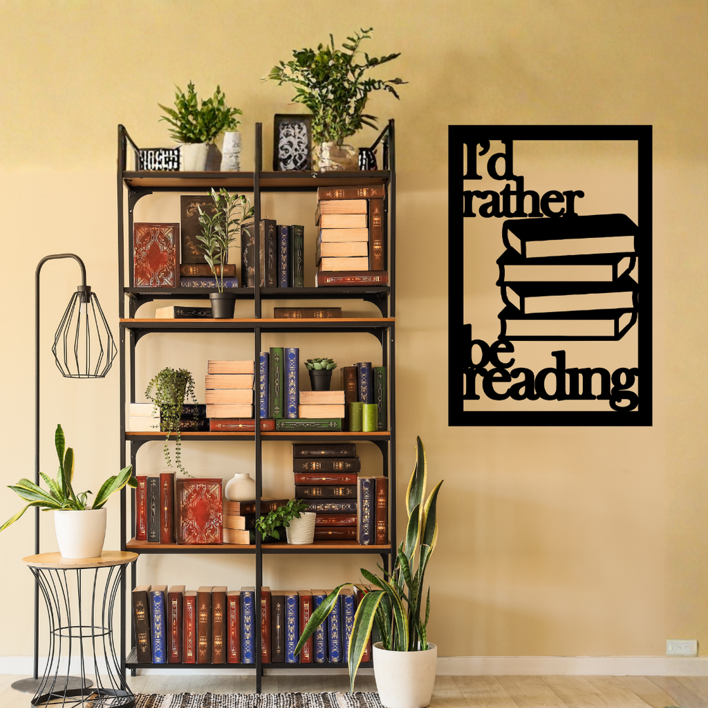 I'd Rather Be Reading | Book Stack Metal Wall Art showcased beside a bookshelf filled with books and decorative plants.