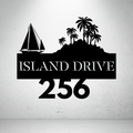 Metal house number sign with sailboat and island design on a grey background