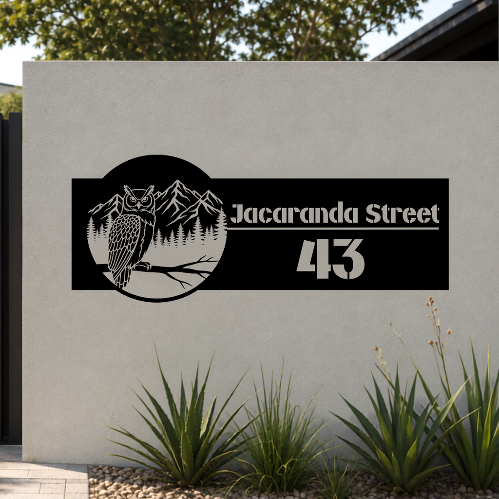 Jacaranda Street owl personalised metal house number sign mounted on a modern rendered entrance wall.