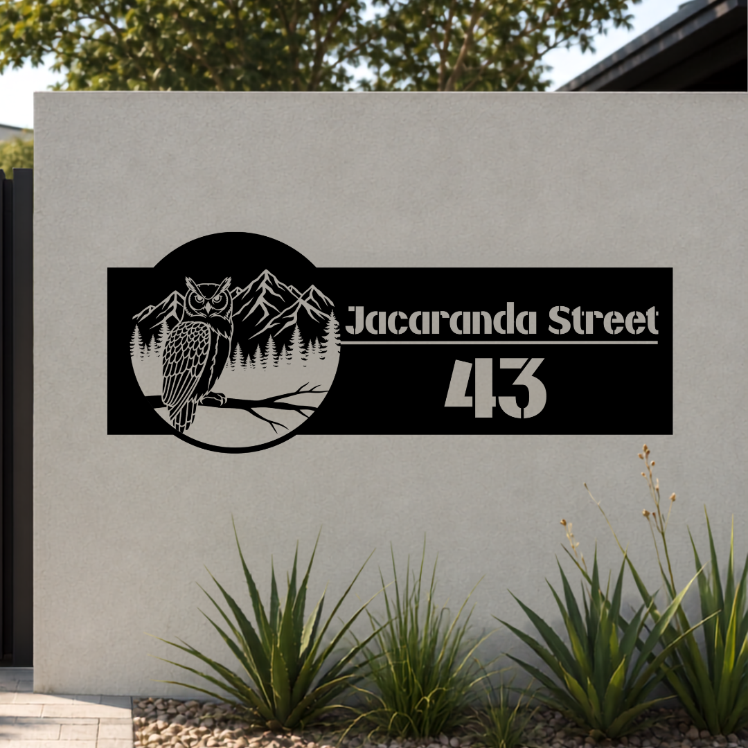 Jacaranda Street owl personalised metal house number sign mounted on a modern rendered entrance wall.