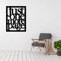 Just One More Page | Book Lover Metal Wall Art displayed on a modern living room wall above a contemporary accent chair.