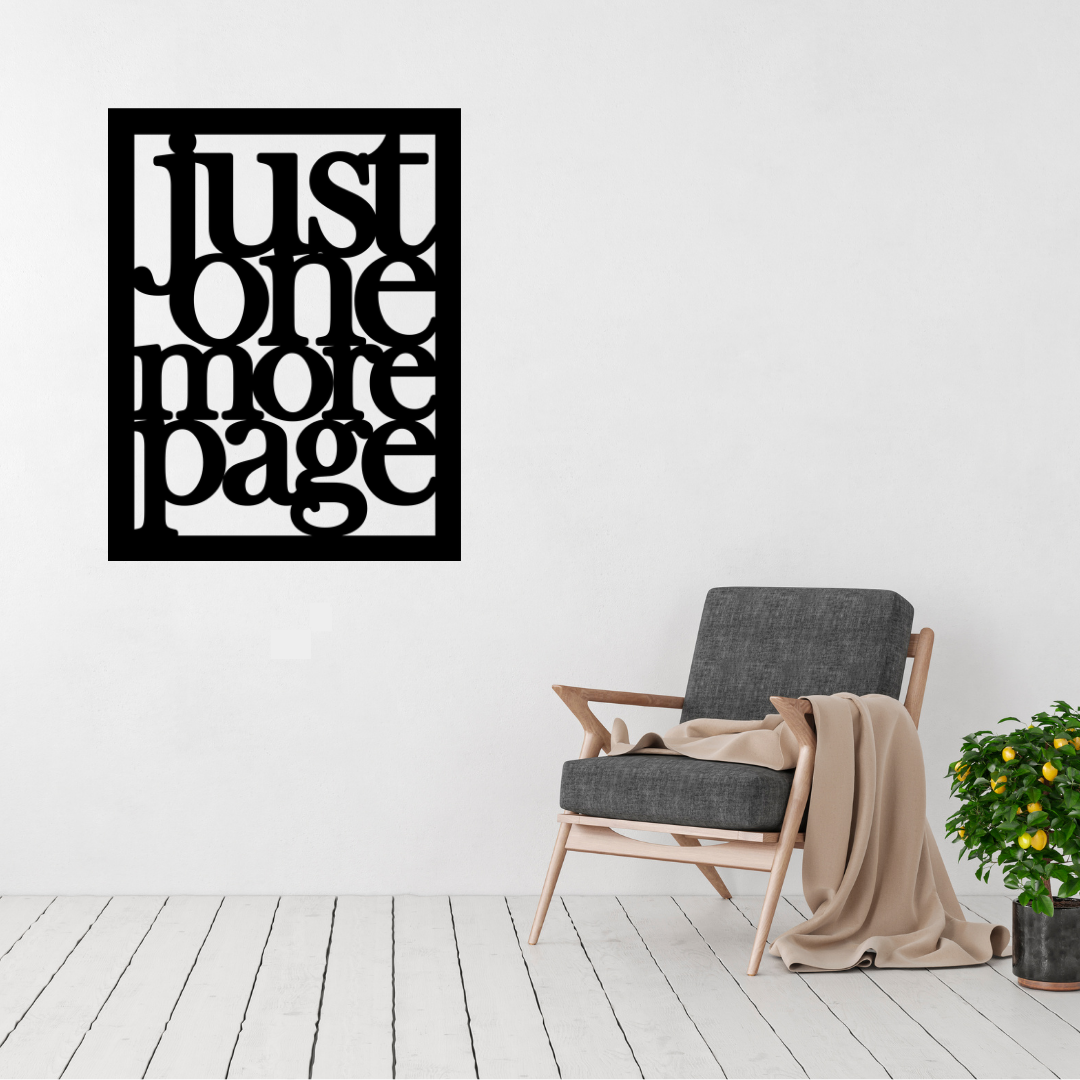 Just One More Page | Book Lover Metal Wall Art displayed on a modern living room wall above a contemporary accent chair.