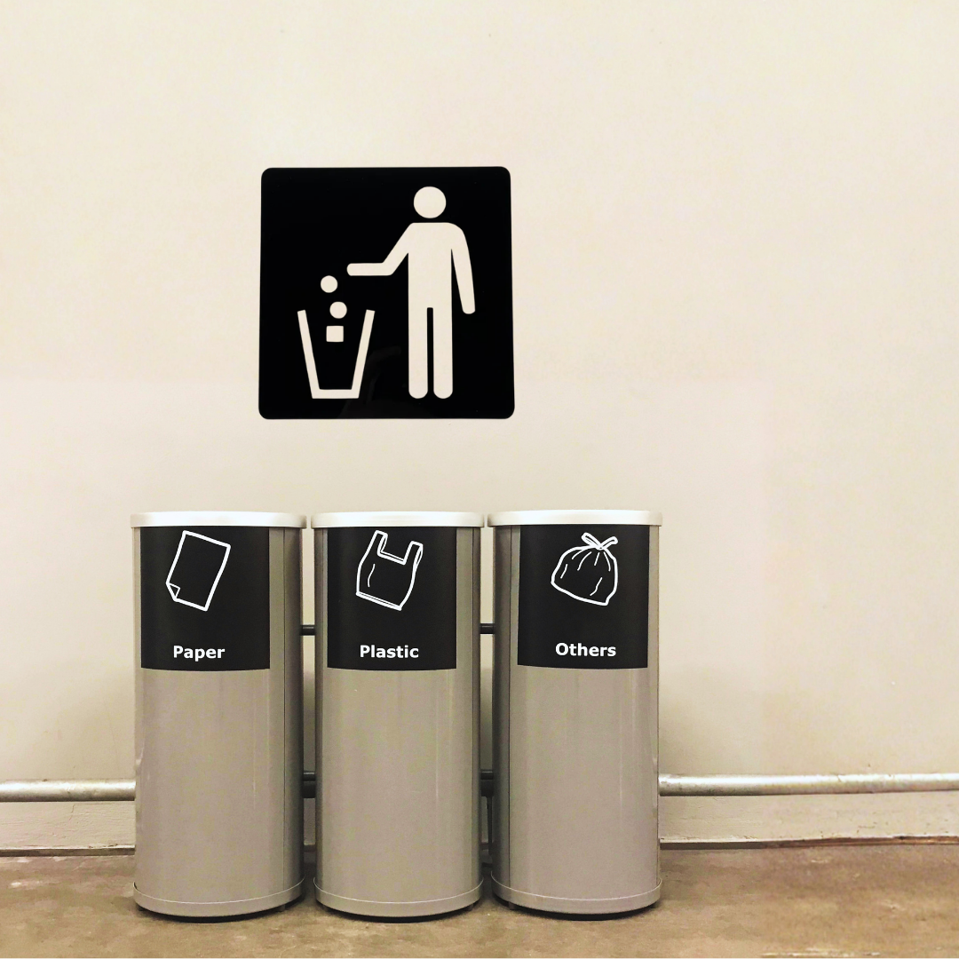 Keep It Clean Litter Bin Metal Sign displayed above recycling and waste bins in a commercial setting.
