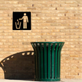 Keep It Clean Litter Bin Metal Sign mounted on an outdoor brick wall above a public waste bin.