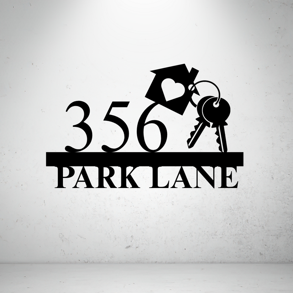 Metal house number sign with decorative key design on a grey background