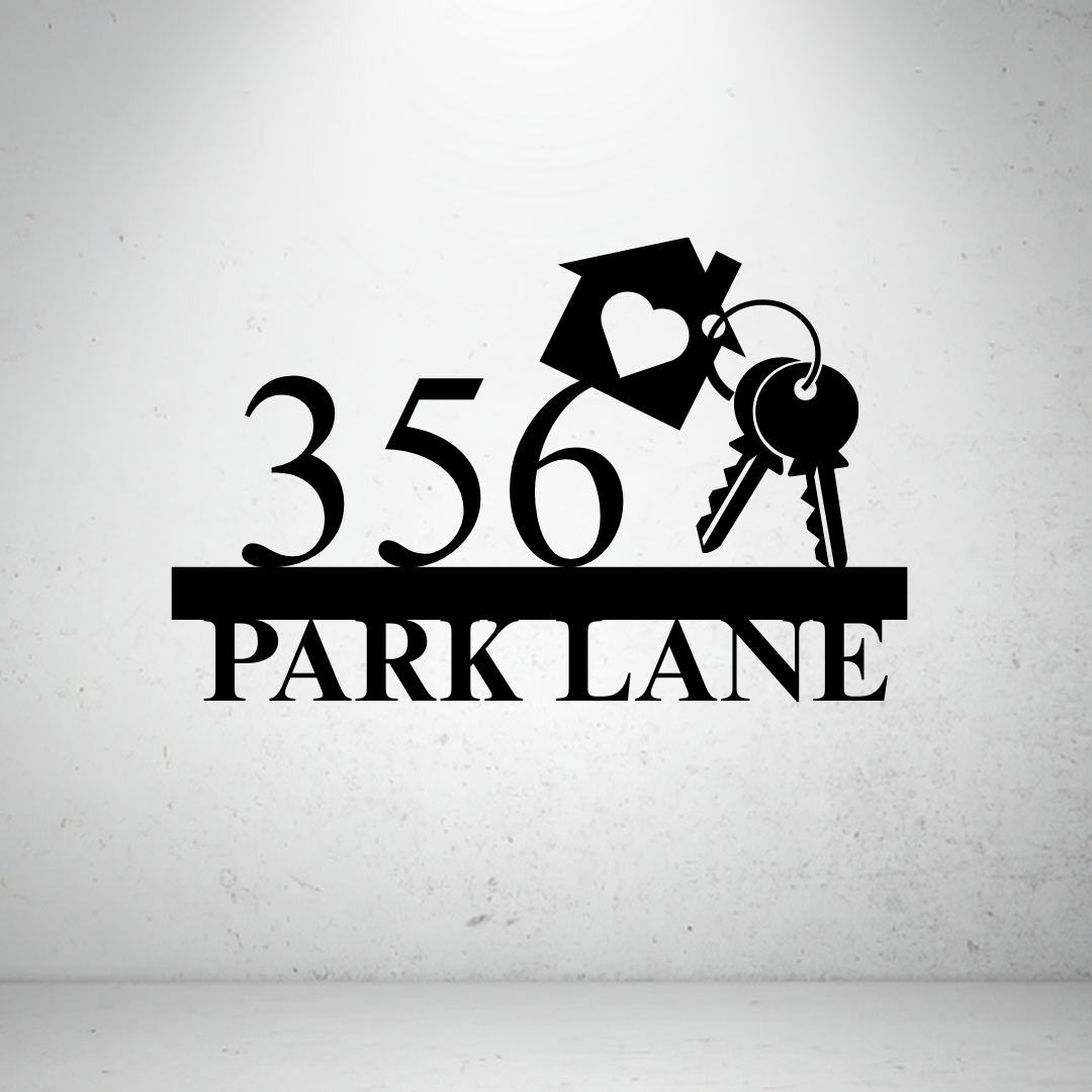 Metal house number sign with decorative key design on a grey background