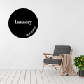 Modern circular Laundry metal wall sign with "Help Wanted" displayed in a bright contemporary home interior.