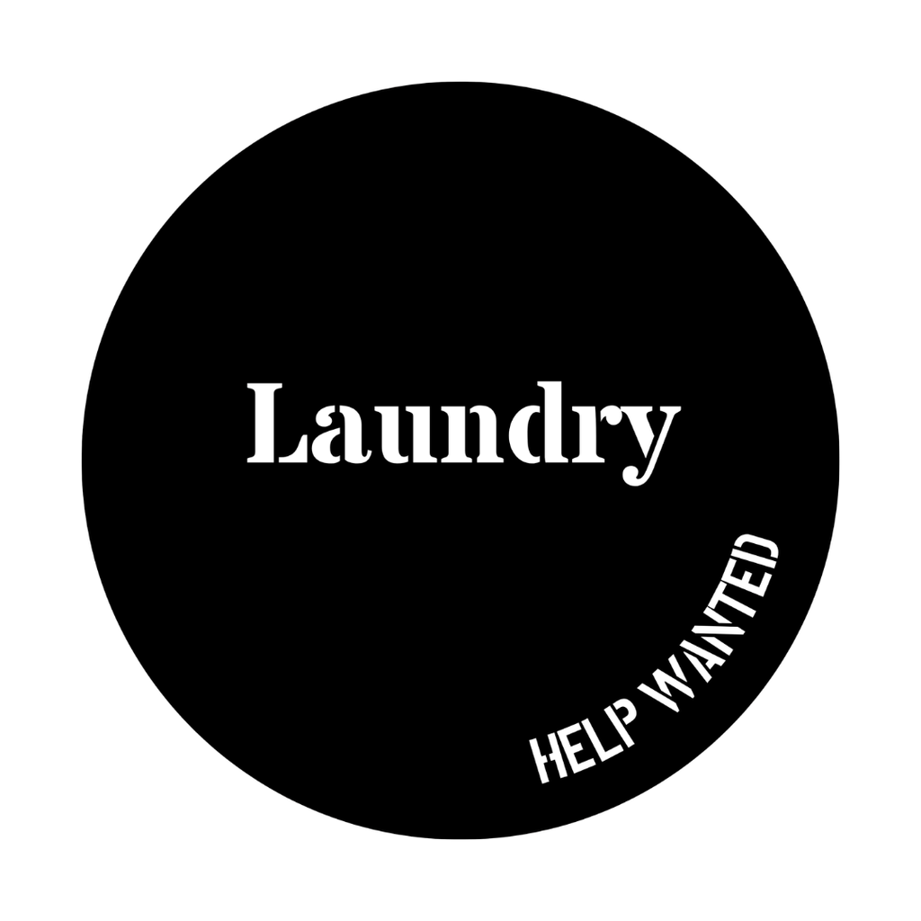 Close-up of the Laundry Home Essentials metal sign featuring the playful "Help Wanted" wording in a circular laser-cut design.
