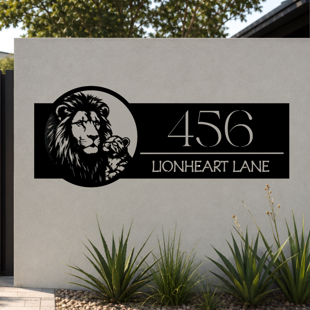 Lionheart Lane lion family personalised metal house number sign mounted on a modern rendered entrance wall.