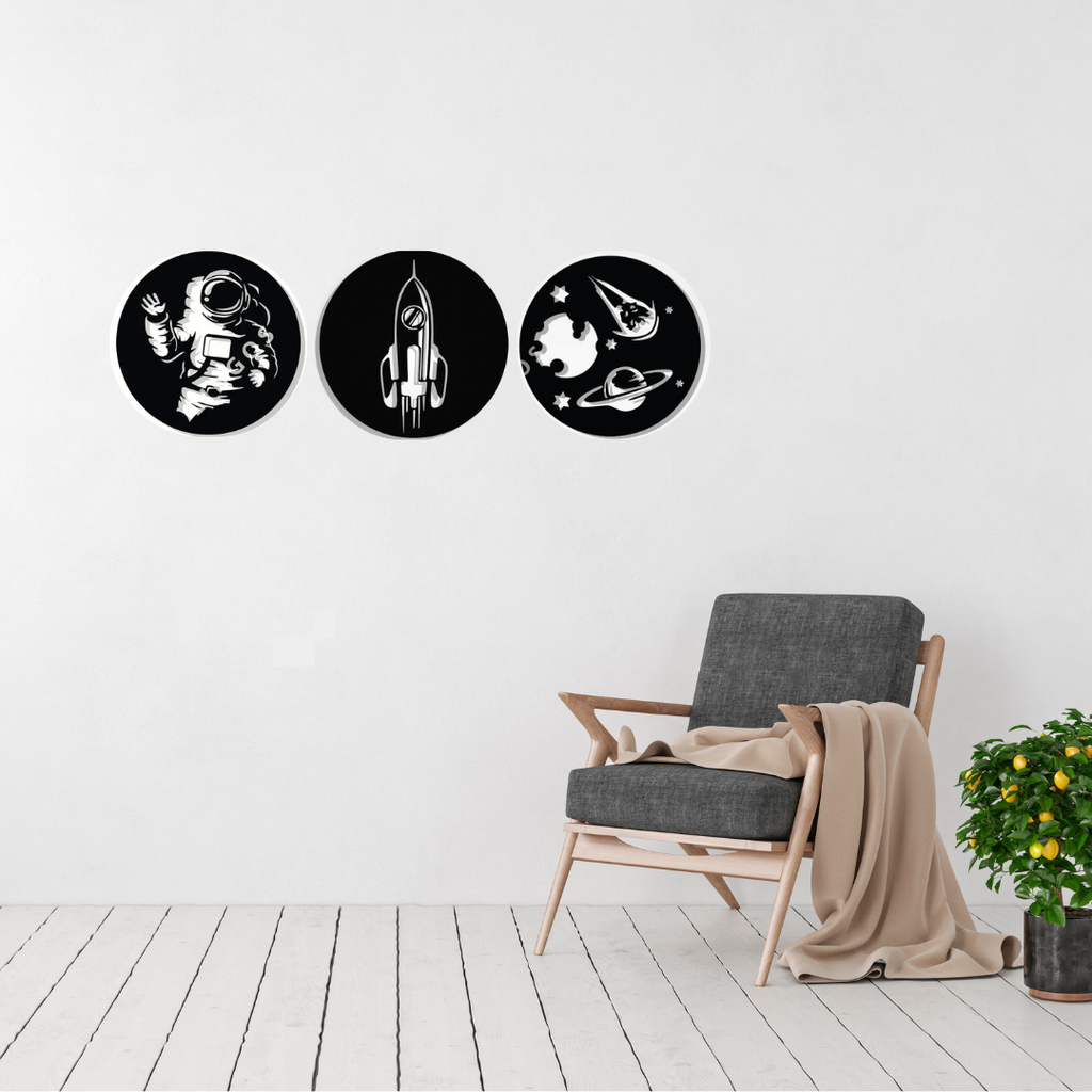 Little Explorers Collection | Space Adventure Metal Wall Art Set displayed in a modern children's bedroom, featuring three circular laser-cut steel designs of an astronaut, rocket and outer space scene.