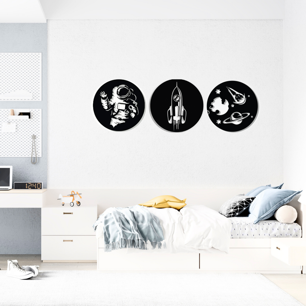 Little Explorers Collection | Space Adventure Metal Wall Art Set installed above a child's bed, showcasing astronaut, rocket and galaxy-themed metal wall art.