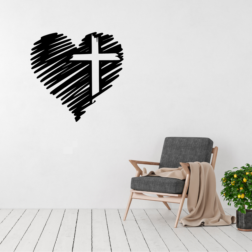 Love and Faith heart cross metal wall art displayed above a contemporary chair in a modern interior